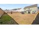 Large fenced backyard offering plenty of space for recreation, with a trampoline and patio furniture at 1333 Maston Rd, Auburn, GA 30011