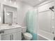 Bright bathroom featuring a tub with shower, modern vanity, and neutral color palette at 1333 Maston Rd, Auburn, GA 30011