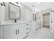 Bright bathroom featuring double vanity, framed mirrors, walk-in shower, and marble-look tile floor at 4352 Riverlake Way, Snellville, GA 30039