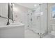 Bathroom featuring walk-in shower, single vanity, framed mirror, and marble-look tile floor at 4352 Riverlake Way, Snellville, GA 30039