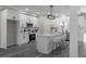 Well-lit kitchen with a center island, white cabinetry, stainless steel appliances, and modern lighting at 4352 Riverlake Way, Snellville, GA 30039