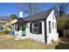 This home features a gray roof, black trim, a green door, and white painted siding at 232 Mathewson Sw Pl, Atlanta, GA 30314