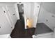 Hallway with dark wood floors, a glass shower, and white doors with black hardware at 232 Mathewson Sw Pl, Atlanta, GA 30314