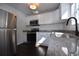 This kitchen features granite countertops, stainless steel appliances and bright lighting at 232 Mathewson Sw Pl, Atlanta, GA 30314