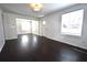 This living room features white walls, dark hardwood floors and bright lighting at 232 Mathewson Sw Pl, Atlanta, GA 30314