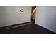 Room featuring dark wood floors, white walls, and access to the stairs at 232 Mathewson Sw Pl, Atlanta, GA 30314