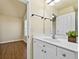 Bathroom with a bright single sink vanity, a large mirror and hardwood flooring in adjacent room at 2349 Harshaw Ave, Lawrenceville, GA 30043