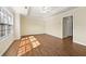Large, sunlit bedroom featuring hardwood floors, tray ceiling with fan and large windows at 2349 Harshaw Ave, Lawrenceville, GA 30043
