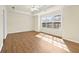 Spacious sunlit bedroom featuring hardwood floors, tray ceiling with fan and large windows at 2349 Harshaw Ave, Lawrenceville, GA 30043