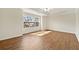 Large, sunlit bedroom featuring hardwood floors, tray ceiling with fan and large windows at 2349 Harshaw Ave, Lawrenceville, GA 30043