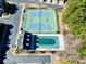 Overhead view of community amenities featuring a pool, tennis courts, and a parking area at 2349 Harshaw Ave, Lawrenceville, GA 30043