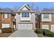 Charming townhome featuring a brick facade, a two-car garage, and a well-maintained lawn at 2349 Harshaw Ave, Lawrenceville, GA 30043