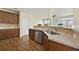 Kitchen area featuring hardwood floors, stainless steel appliances, dark cabinets, and a tile backsplash at 2349 Harshaw Ave, Lawrenceville, GA 30043