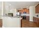 Kitchen showcases hardwood floors, a breakfast bar, stainless steel appliances, and dark wood cabinets at 2349 Harshaw Ave, Lawrenceville, GA 30043
