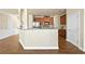 Open kitchen featuring hardwood floors, a breakfast bar, stainless steel appliances, and wood cabinets at 2349 Harshaw Ave, Lawrenceville, GA 30043