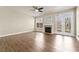 Bright living room with a fireplace, ceiling fan, hardwood floors, and a glass pane door to the outside at 2349 Harshaw Ave, Lawrenceville, GA 30043