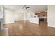 Open-concept living space with hardwood floors connecting to kitchen with breakfast bar at 2349 Harshaw Ave, Lawrenceville, GA 30043