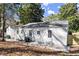 Back exterior features a white wall, multiple windows, an air conditioning system and a fence at 1428 Pinehurst Sw Dr, Atlanta, GA 30311