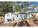 Exterior of the home features white siding, a small back porch, and a fenced yard at 1428 Pinehurst Sw Dr, Atlanta, GA 30311