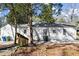 Exterior home view showcases the back of the house with white siding, a small porch and an air conditioning unit at 1428 Pinehurst Sw Dr, Atlanta, GA 30311