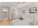 Cozy bedroom featuring an ensuite bathroom, light hardwood floors, and comfortable textures at 1428 Pinehurst Sw Dr, Atlanta, GA 30311