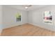 Bright, empty bedroom with light hardwood floors and two windows with blinds at 1428 Pinehurst Sw Dr, Atlanta, GA 30311