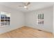 Bright, empty bedroom with light hardwood floors and two windows with blinds at 1428 Pinehurst Sw Dr, Atlanta, GA 30311
