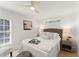 Bright bedroom with stylish ceiling fan, woven headboard, and neutral decor at 1428 Pinehurst Sw Dr, Atlanta, GA 30311