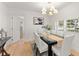 Dining room with modern table set and decorative lighting, with hardwood flooring at 1428 Pinehurst Sw Dr, Atlanta, GA 30311