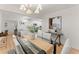 Bright dining room with hardwood floors and a modern table set at 1428 Pinehurst Sw Dr, Atlanta, GA 30311