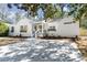 Charming home featuring a large driveway, flower boxes on windows, and white painted brick at 1428 Pinehurst Sw Dr, Atlanta, GA 30311