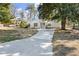 Charming one-story home features a long driveway and well-maintained front yard with mature trees and landscaping at 1428 Pinehurst Sw Dr, Atlanta, GA 30311