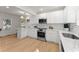 Modern kitchen with white cabinetry, stainless steel appliances, quartz countertops, and a breakfast bar with lots of space at 1428 Pinehurst Sw Dr, Atlanta, GA 30311