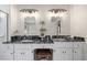 This bathroom features double sinks with black granite countertops and vanity sitting area at 1558 Amberwood Creek Nw Dr, Kennesaw, GA 30152