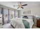 Comfortable bedroom featuring soft carpet, natural lighting, and a ceiling fan at 1558 Amberwood Creek Nw Dr, Kennesaw, GA 30152