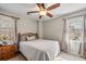 Cozy bedroom offering carpet, neutral walls, a ceiling fan, and two windows at 1558 Amberwood Creek Nw Dr, Kennesaw, GA 30152