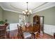 Charming dining room featuring hardwood floors, chandelier, and elegant decor at 1558 Amberwood Creek Nw Dr, Kennesaw, GA 30152