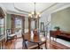 Elegant dining room featuring hardwood floors, crown molding, and beautiful chandelier at 1558 Amberwood Creek Nw Dr, Kennesaw, GA 30152