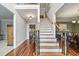 Inviting foyer with hardwood floors and a staircase featuring decorative railings at 1558 Amberwood Creek Nw Dr, Kennesaw, GA 30152