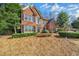 Traditional brick home featuring well-maintained landscaping and ample natural light at 1558 Amberwood Creek Nw Dr, Kennesaw, GA 30152
