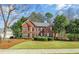 Charming two-story brick home with manicured front yard and lush landscaping at 1558 Amberwood Creek Nw Dr, Kennesaw, GA 30152