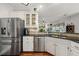 Spacious kitchen featuring stainless steel appliances, granite countertops, and white cabinetry at 1558 Amberwood Creek Nw Dr, Kennesaw, GA 30152