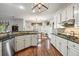 Bright eat-in kitchen featuring white cabinets, granite countertops, and stainless steel appliances at 1558 Amberwood Creek Nw Dr, Kennesaw, GA 30152
