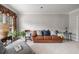 Cozy living room featuring a brown leather couch, decorative pillows, and plush carpeting at 1558 Amberwood Creek Nw Dr, Kennesaw, GA 30152
