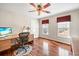 Well-lit office with hardwood floors offers a comfortable workspace with a desk, chair, and natural light at 1558 Amberwood Creek Nw Dr, Kennesaw, GA 30152