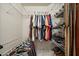 Well-organized walk-in closet features ample storage space with shelving and rods for clothing and shoes at 1558 Amberwood Creek Nw Dr, Kennesaw, GA 30152