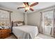 Bright bedroom featuring a bed, side table, and two windows that provide natural light at 1558 Nw Amberwood Creek Nw Dr, Kennesaw, GA 30152