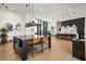 Open-concept common area with large table, bar seating, and stylish pendant lighting at 788 W Marietta Nw St # 116, Atlanta, GA 30318
