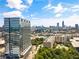 Modern high-rise building featuring reflective glass exterior and city views, set against a blue sky with scattered clouds at 788 W Marietta Nw St # 116, Atlanta, GA 30318