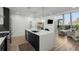 Sleek, modern kitchen featuring a large island with sink and seating, stainless steel appliances, and bright lighting at 788 W Marietta Nw St # 116, Atlanta, GA 30318
